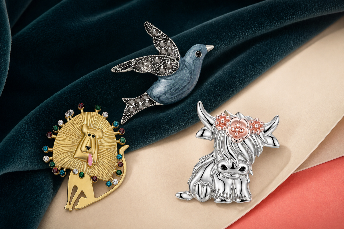 Animal and bird ibiubu brooches arranged on colorful fabric