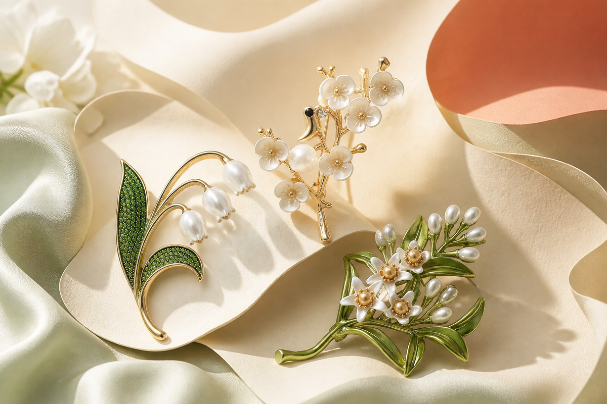 Floral ibiubu brooches arranged on light fabric